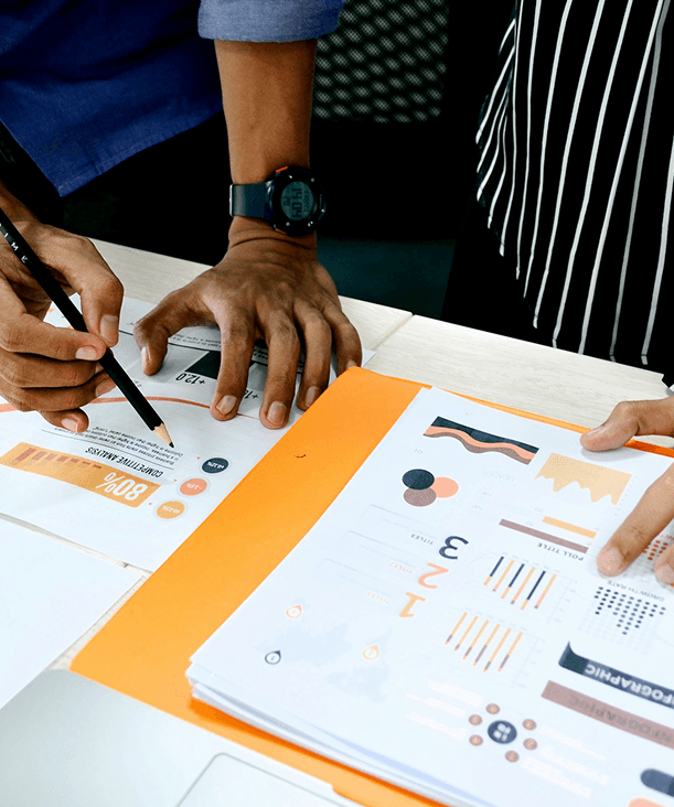 two people in a business setting analyze data on paper